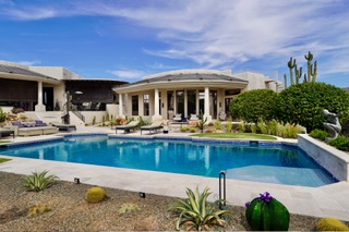 Freeform pool with spa, desert landscaping, and cactus accents