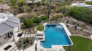 Aerial view of luxury pool with spa and desert landscaping